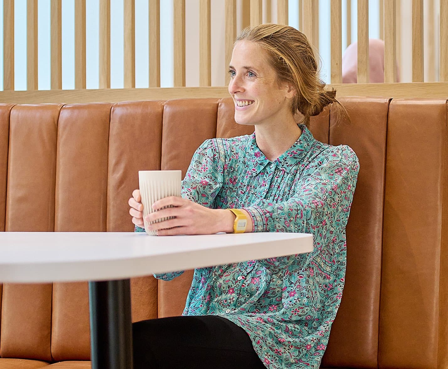 Photo showing person enjoying a hot drink in a Café